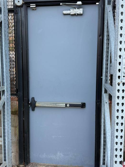 Commercial exit door with panic bar hardware